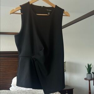 White House Black Market Sleeveless top. Elegant cross peplum and back zipper.